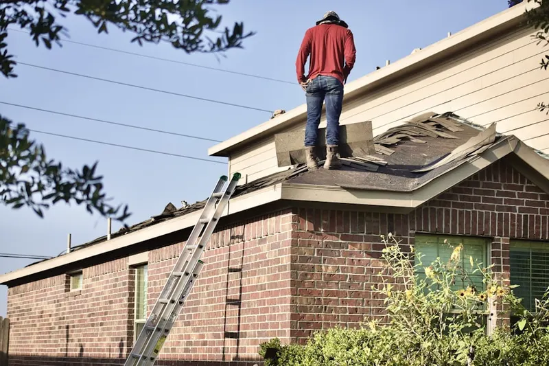 Professional roofer working on a residential roof in Perry Point